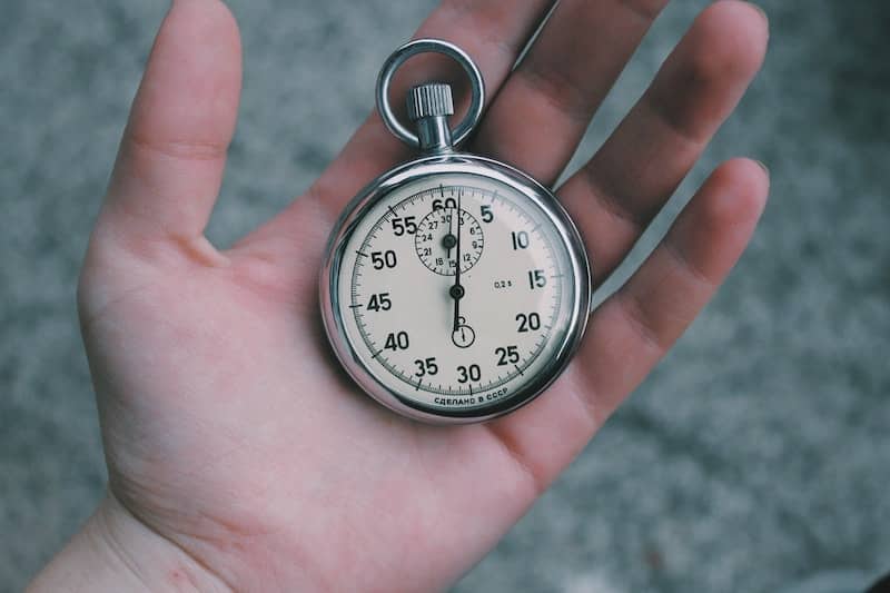 Zoom zoom! This person holding a stopwatch represents WordPress speed improvements gained by caching.