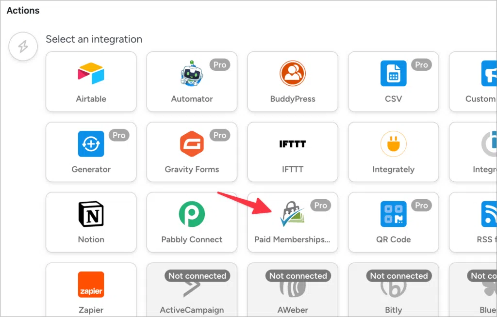 An arrow pointing to 'Paid memberships Pro' underneath 'Actions' in the Uncanny Automator recipe configuration screen.