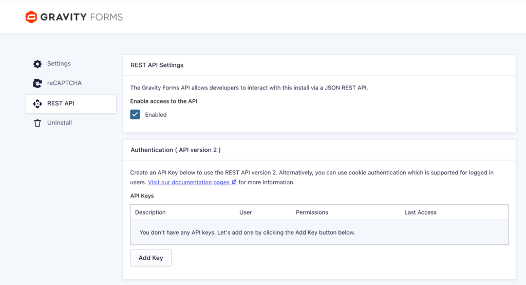 The Gravity Forms REST API settings screen with "Enable access to the API" turned on, showing the Authentication (API version 2) section and an empty API Keys table with an Add Key button.